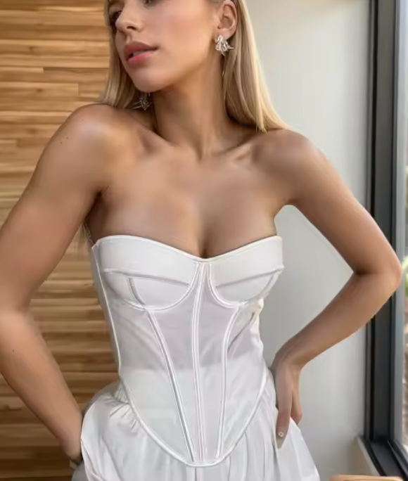 Model wearing a white handmade bustier corset with structured seaming and a flattering, fitted silhouette.