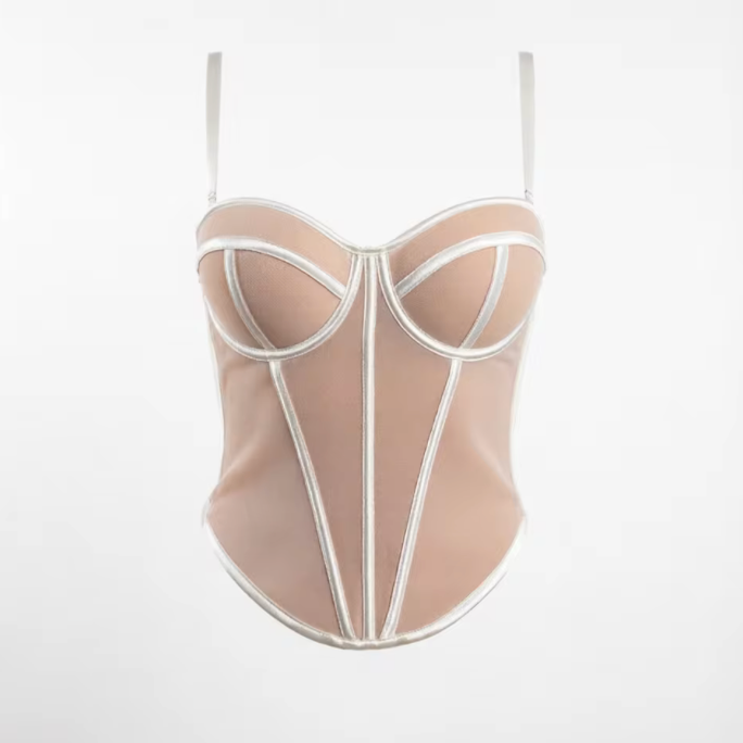 Beige handmade corset bustier with structured white piping, sweetheart neckline, and adjustable spaghetti straps.