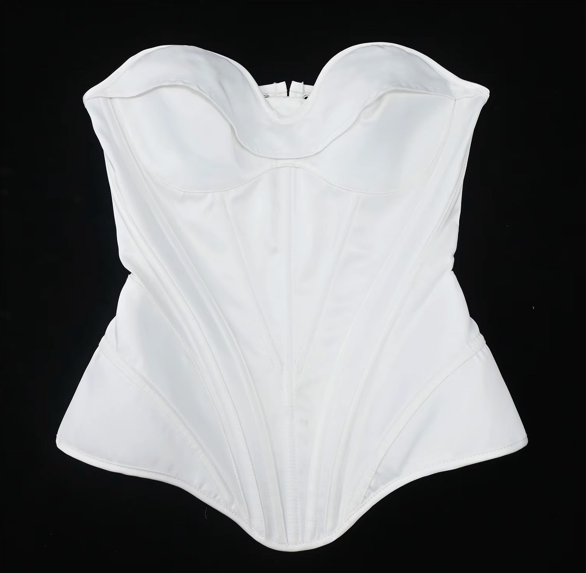 White satin strapless corset bustier with structured boning and a sweetheart neckline on a black background.