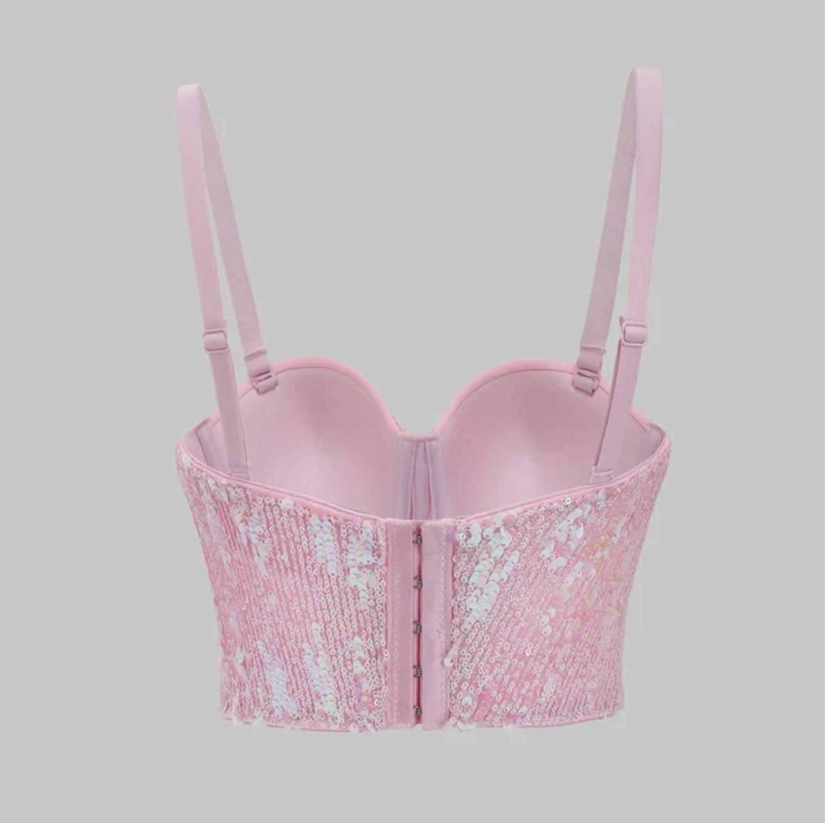 Back view of a pink Y2K-style corset bustier featuring shimmering sequins, adjustable straps, and a hook-and-eye back closure.