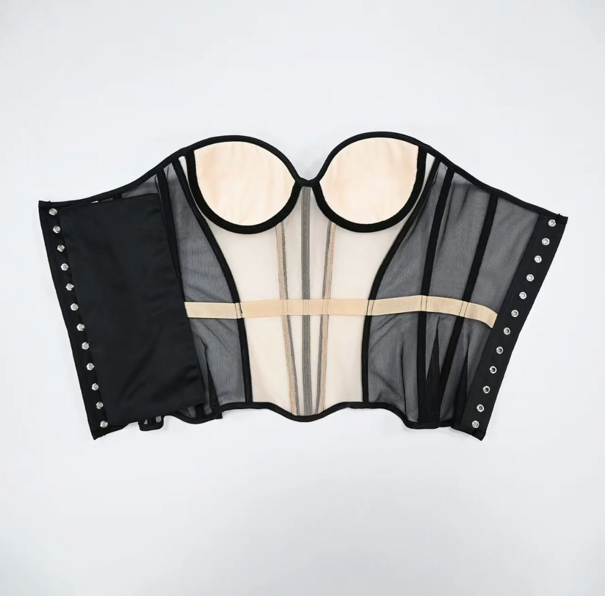 Dora strapless corset in black mesh and beige fabric with structured boning and side hook-and-eye closures.