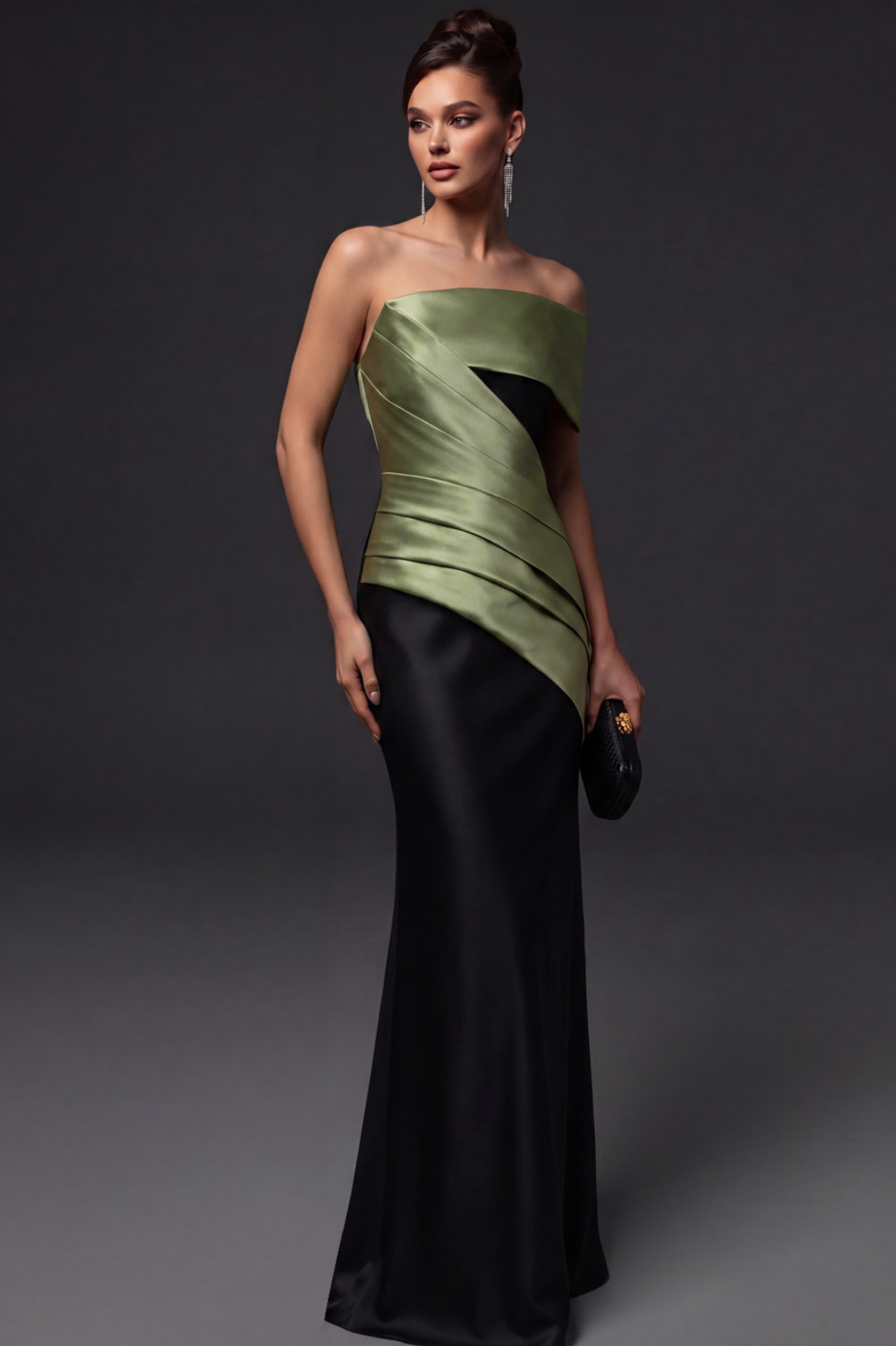 Model wearing a structured, floor-length satin twill gown with a sage green pleated bodice and black skirt.