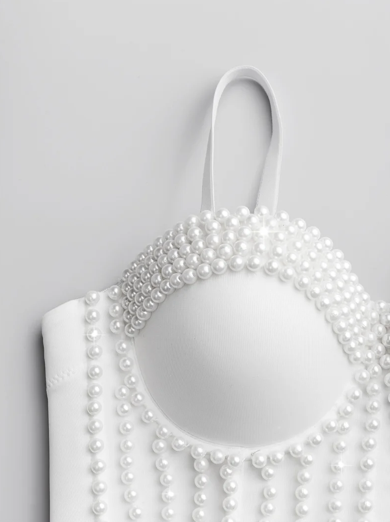 White handmade corset camisole featuring intricate pearl bead embellishments and a structured, modern design.