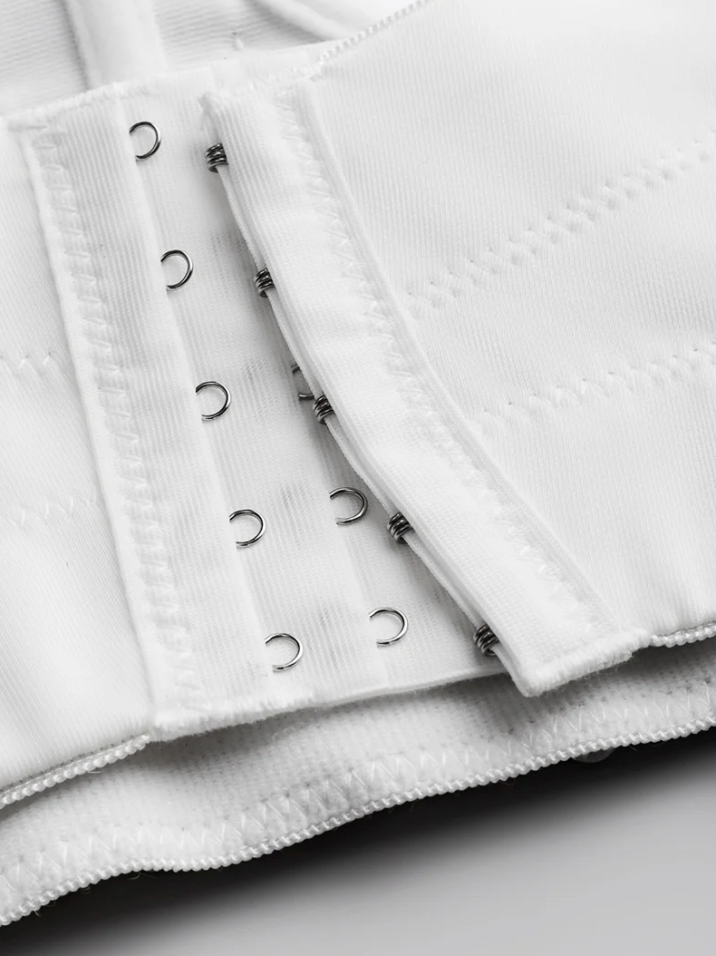 Close-up of a white Ina corset featuring a sturdy hook-and-eye closure system on premium polyester broadcloth fabric.