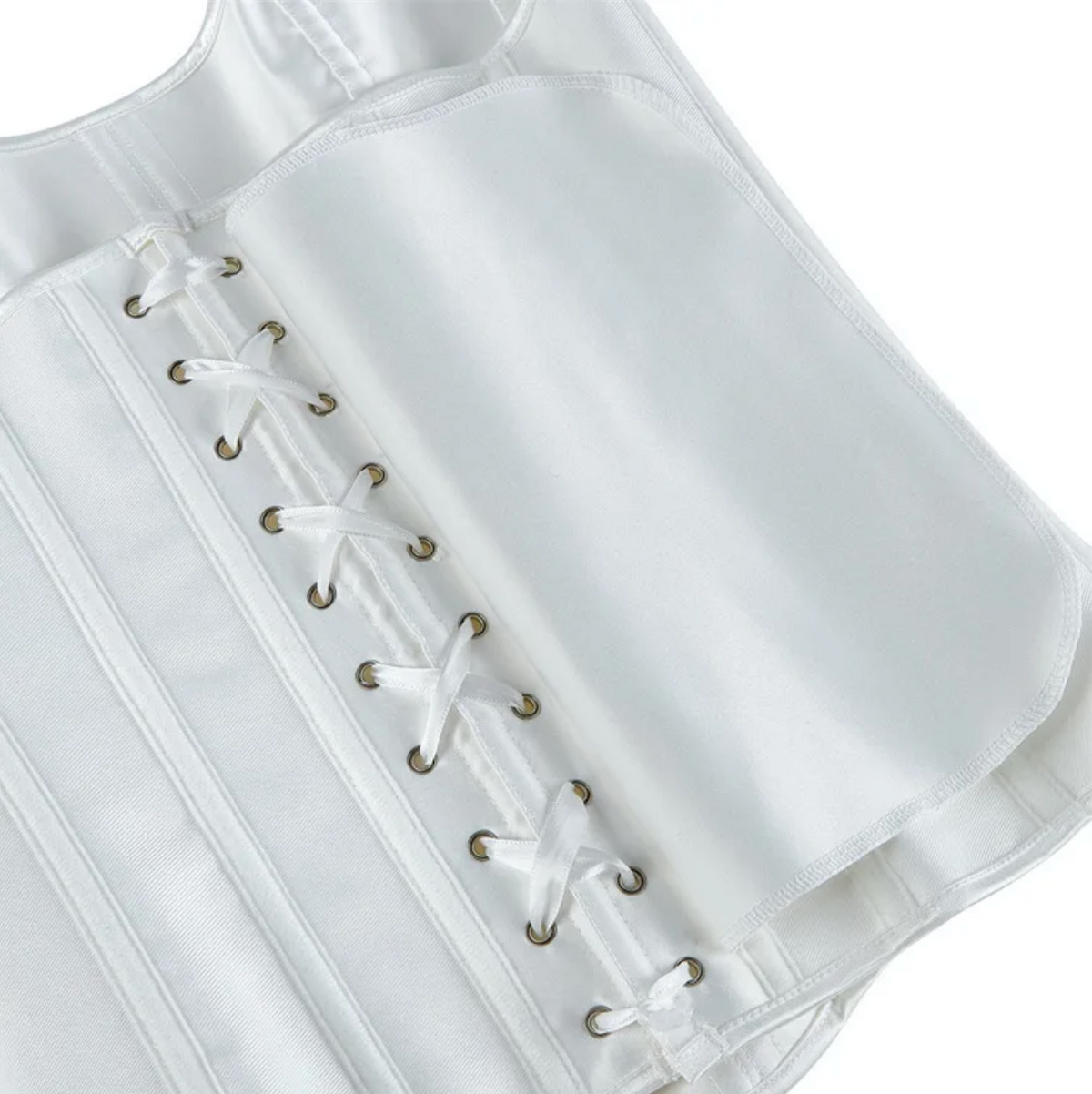 White satin corset bustier featuring structured boning, metal eyelets, and a delicate white ribbon lace-up back closure.